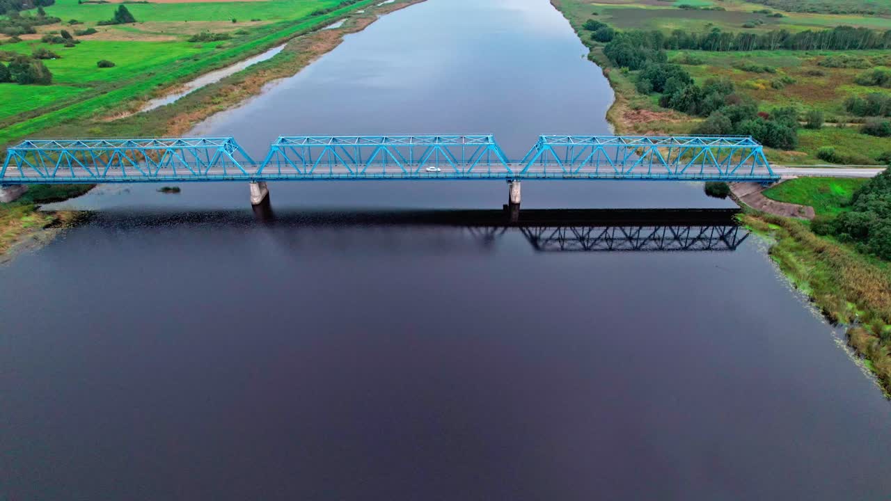 Exploring the tranquil waters beneath the bridge in Latvia