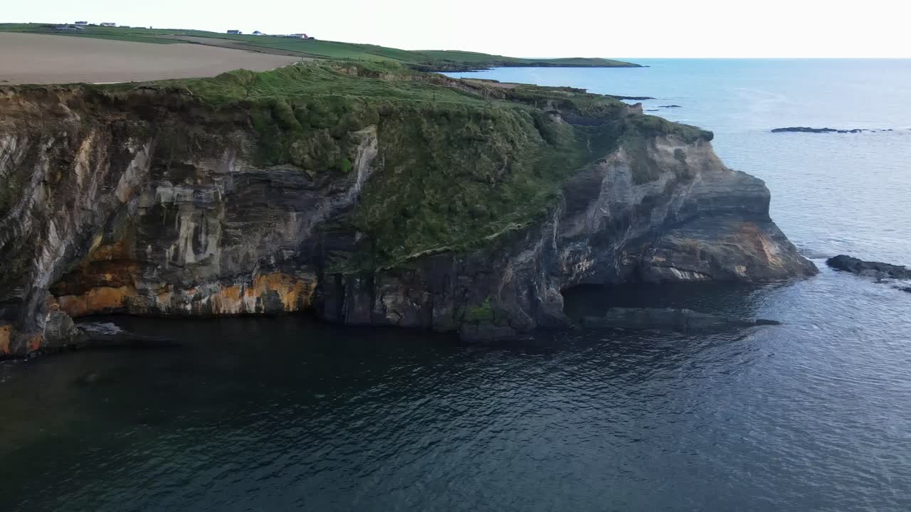 Ocean's edge, a rugged cliffs and farm fields