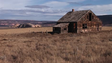 an abandoned settler cabin sits on the plains of america