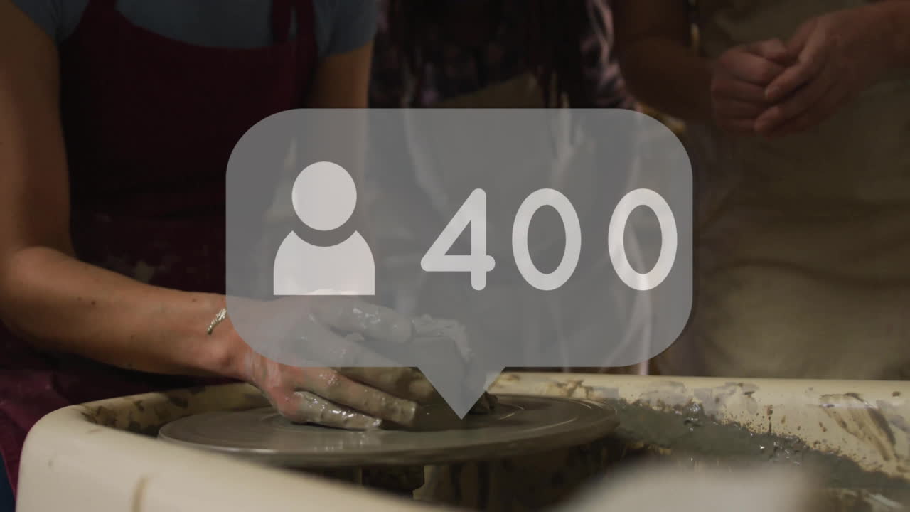 Shaping clay on pottery wheel, artist receiving 500 followers animation notification