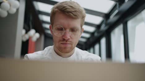 programmer or professional IT specialist is working alone in office, closeup portrait of handsome european man