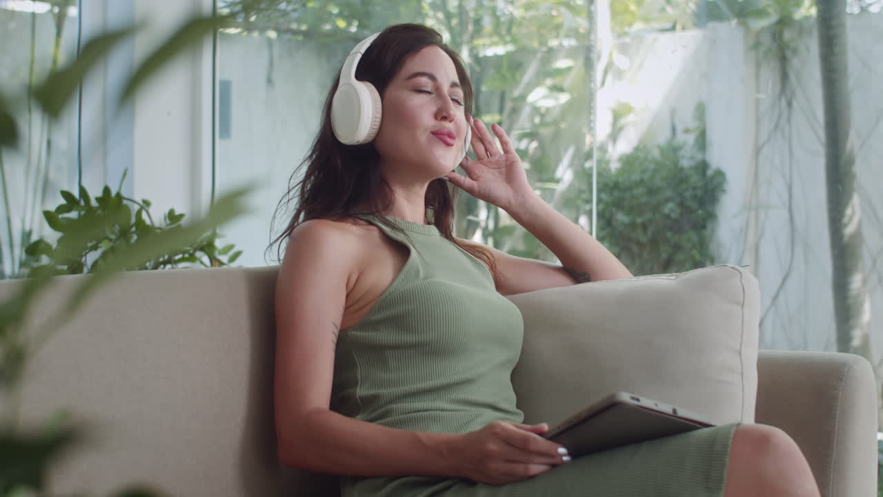 Caucasian Woman Vibing to Music in Headphones