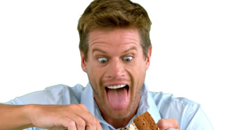 attractive man about to eat a cake on white screen