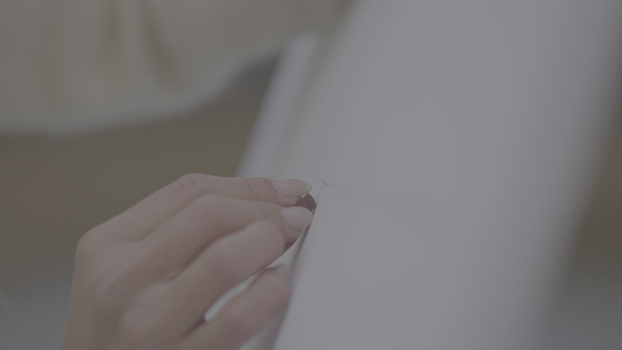 Close-up of hand repairing a piece of cloth