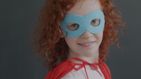 a young girl dressed as a superhero