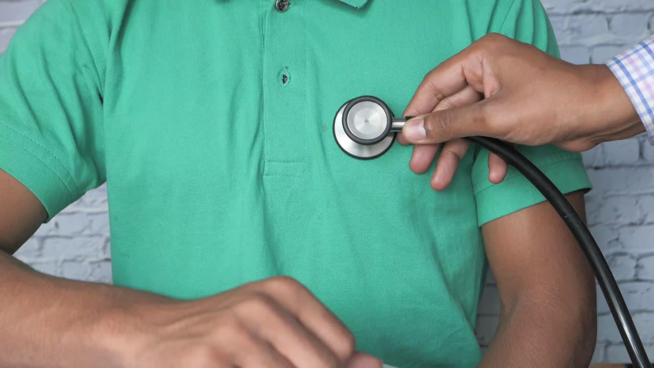 Doctor using a stethoscope to examine a patient's chest