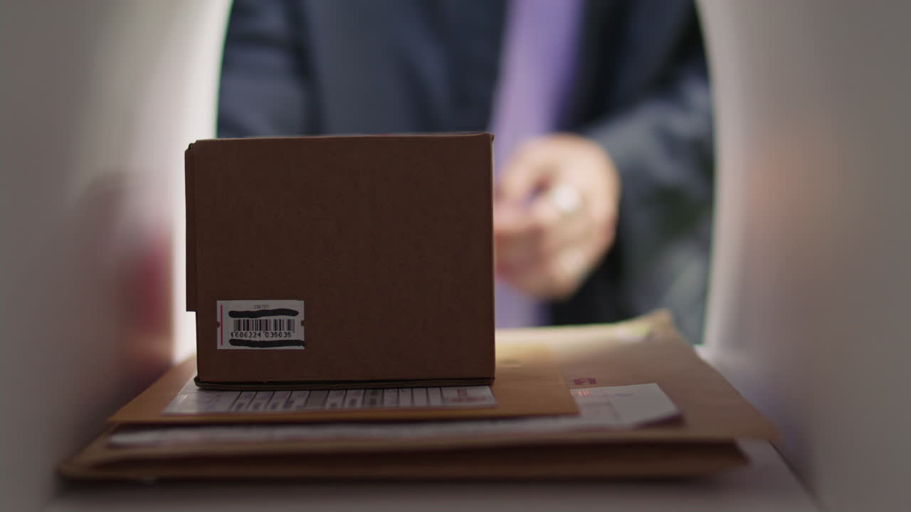 Woman Placing Parcel and Envelopes into Mailbox for Sending