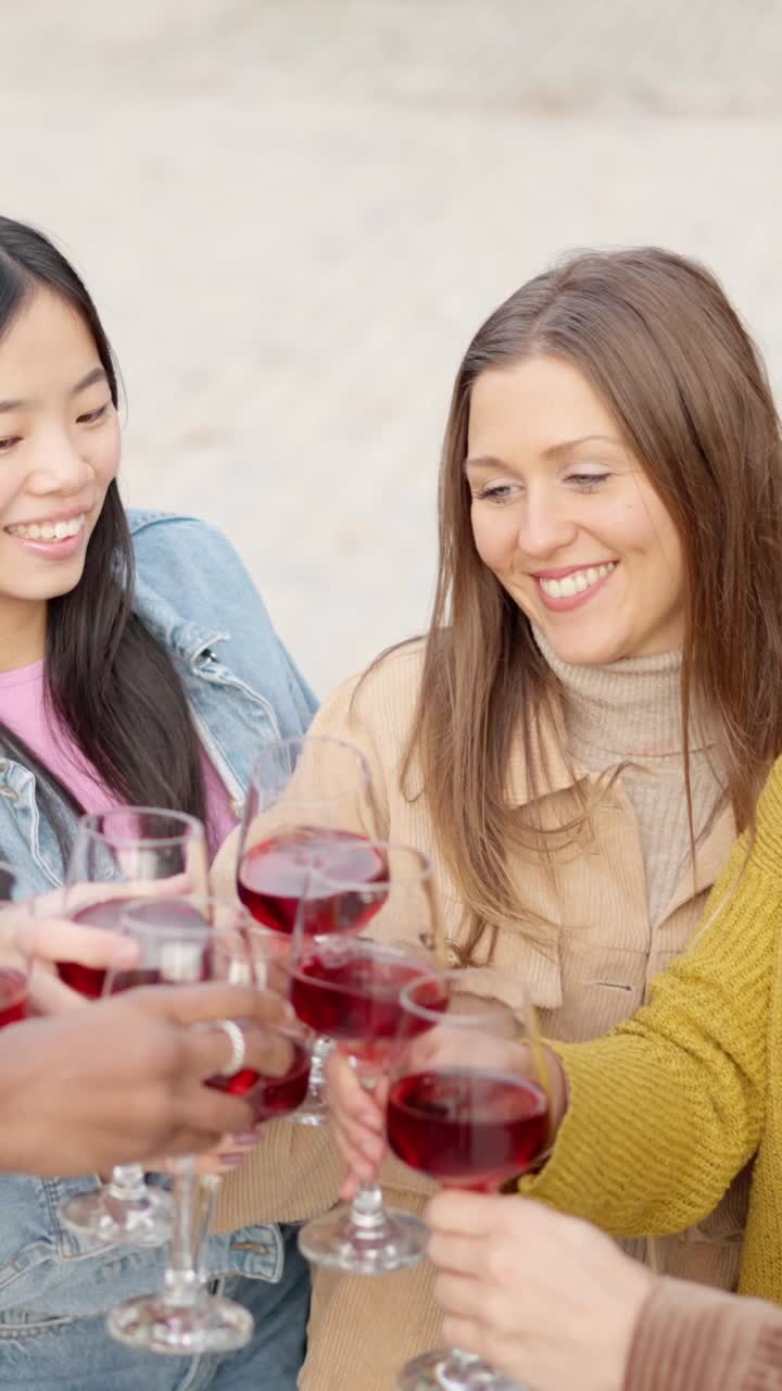 Multicultural young people toasting with wine in the street