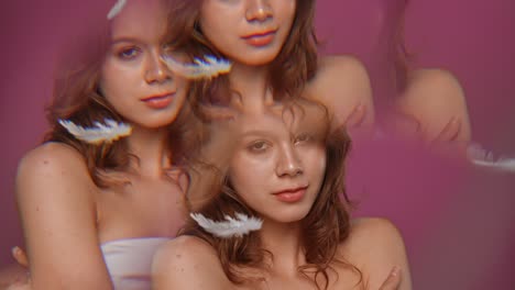 portrait of beautiful young woman on pink background studio portrait of a young woman with natural beauty with mirror effect model posing on pink background with falling white feathers in studio kaleidoscope effect through a glass prism slow motion