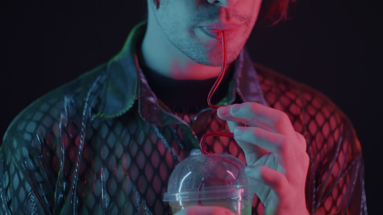Man Drinking Neon Colored Drink
