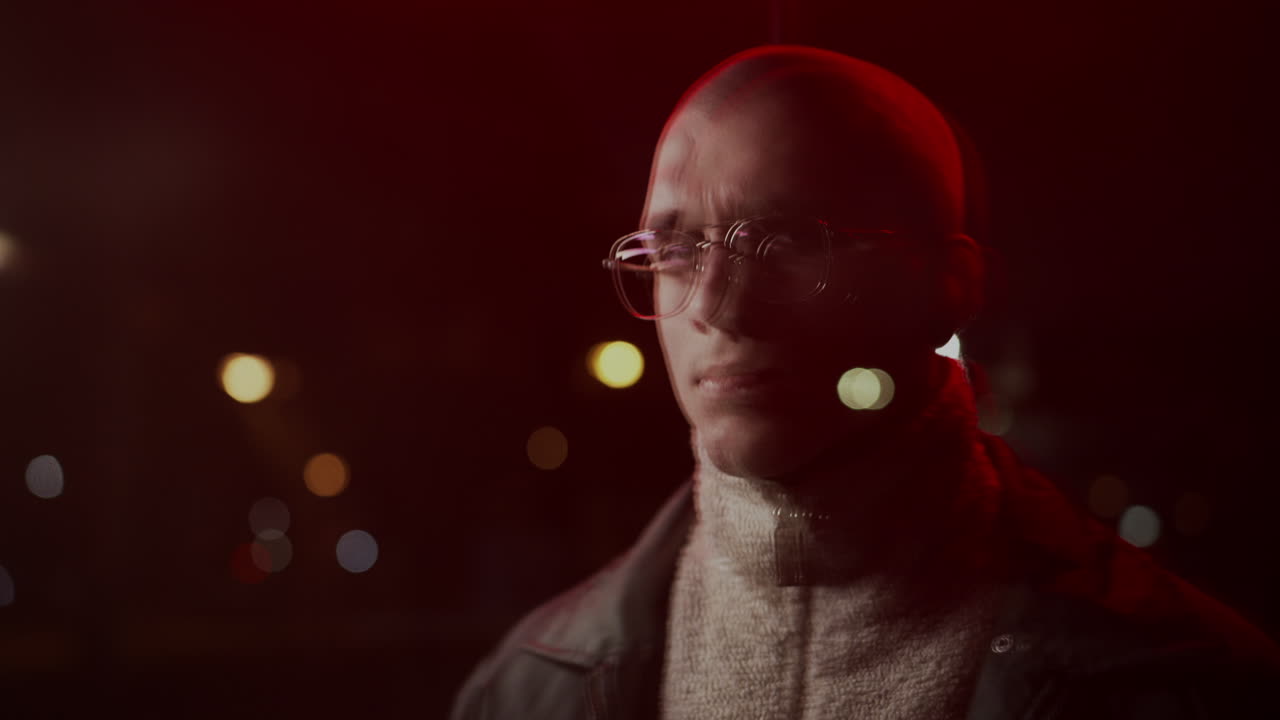 Man with Glasses in Red Light at Night