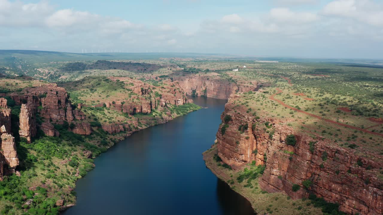 Aerial panorama of Gandikota's dramatic canyon, known as India's Grand Canyon, featuring Pennar River winding between towering red rock cliffs and green plateau landscapes