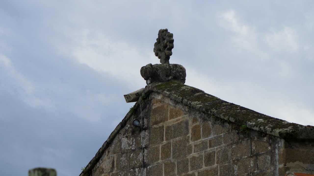 Static view of Santiago de Gustei church facade and stone cross, Coles, Ourense, Spain