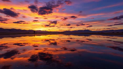 breathtaking sunset reflection over a serene body of water with vibrant colors casting a magical aura on the scenic landscape - a moment captured in time