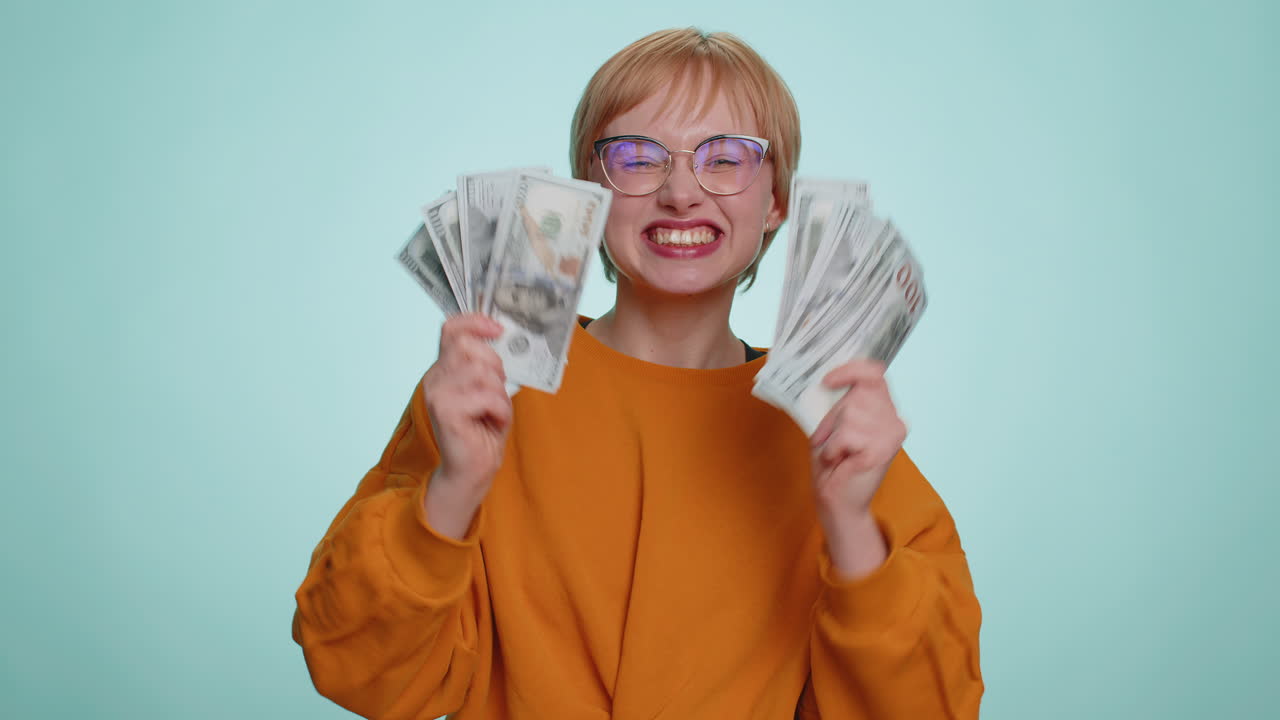 Rich pleased boss woman waving money dollar cash success business career lottery winner big income