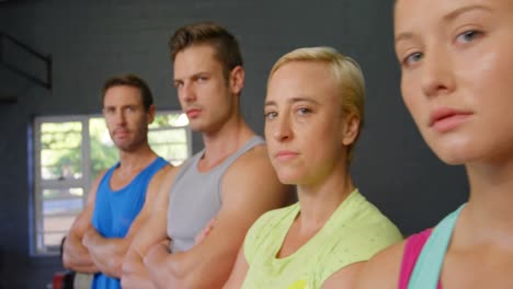 serious fit people posing together in gym