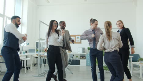 happy business team dancing in office