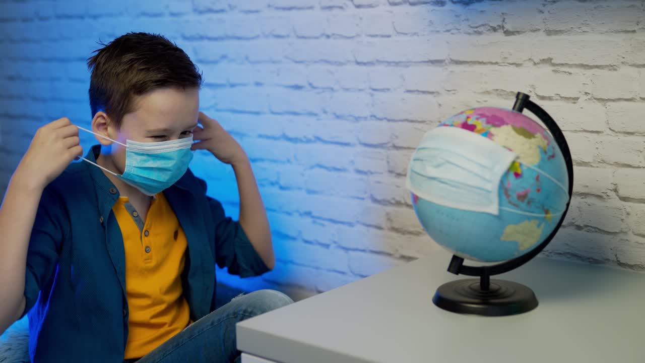 Boy puts on face medical mask against bacteria and viruses.