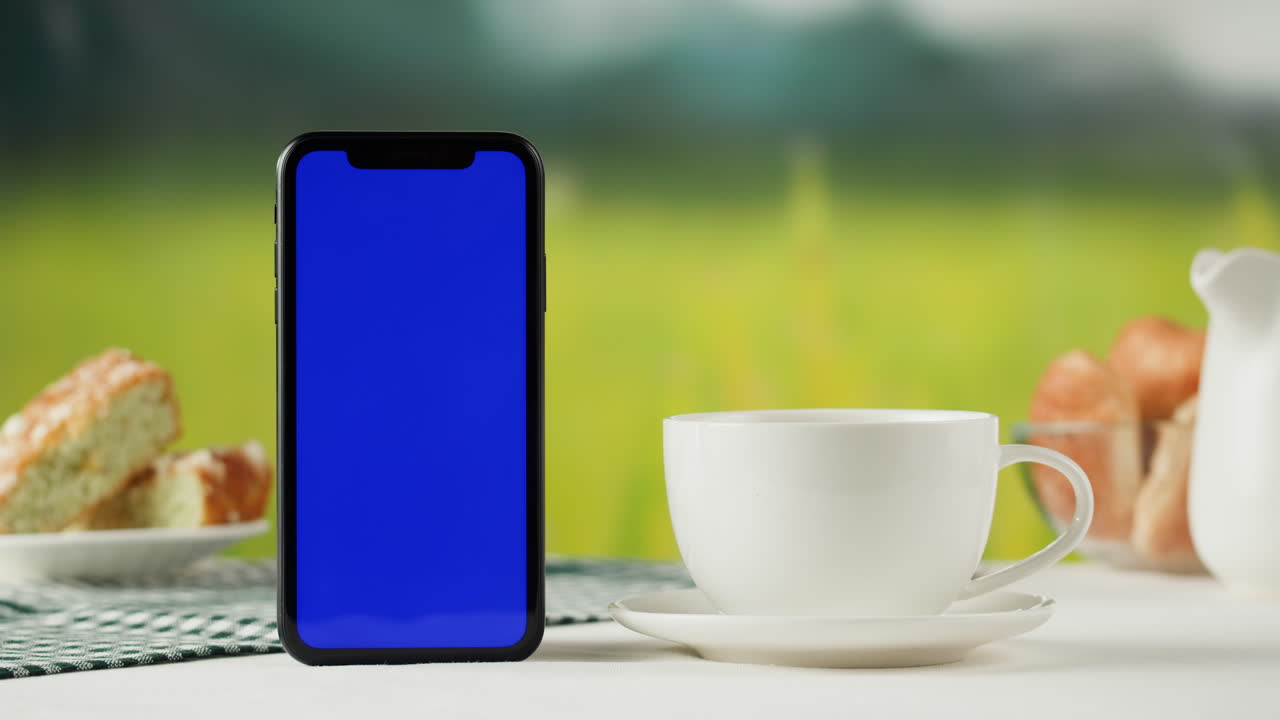Smartphone mockup on a table with breakfast items