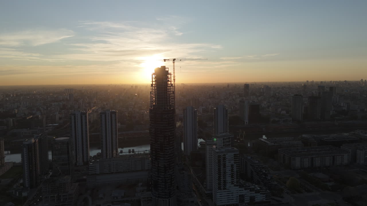 Aerial view of skyscraper under construction and Buenos Aires skyline at sunset, Argentina