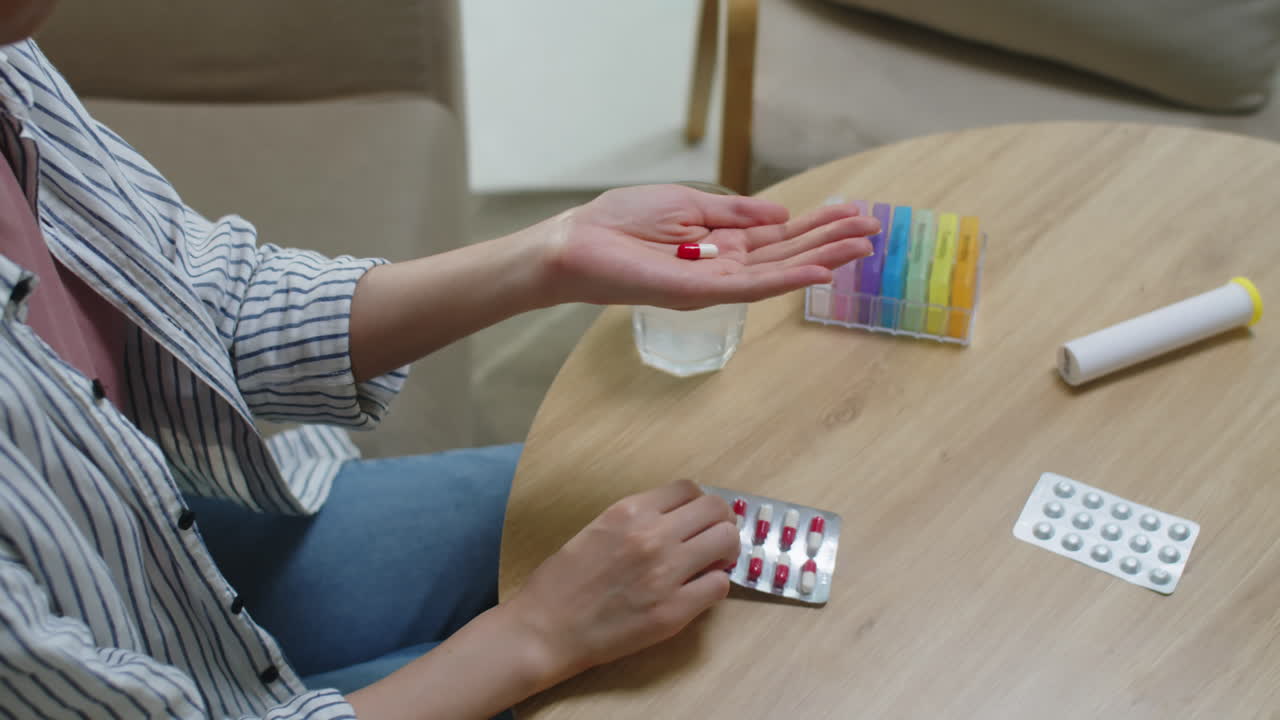 Woman Taking Pill or Vitamin in Morning