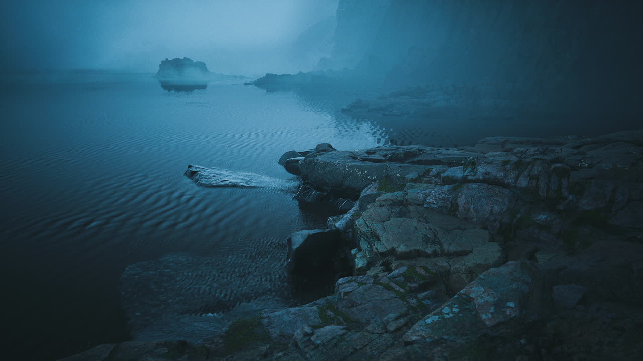 Serene twilight over foggy waters with rocky shores in a tranquil setting