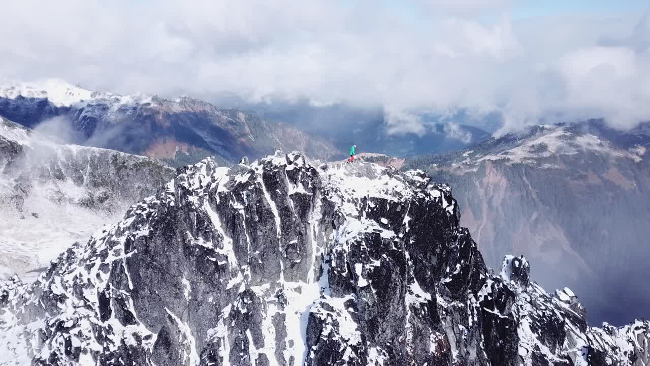 Climber walking on a snowy ridge in the coast mountains of Canada