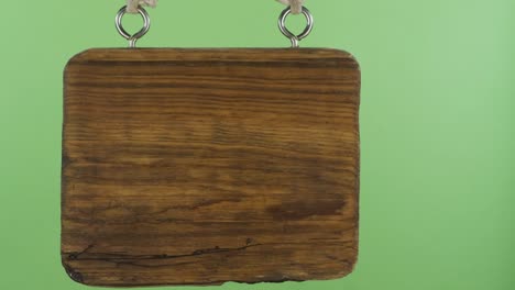 panorama, of a hanging wooden sign. isolated on green screen.