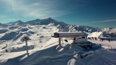 aerial: gondola on mountaintop overlooking ski resort winter valley