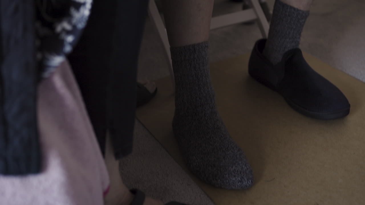 Images of an elderly man and woman sitting indoors