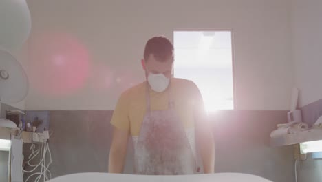 male surfboard maker in his workshop