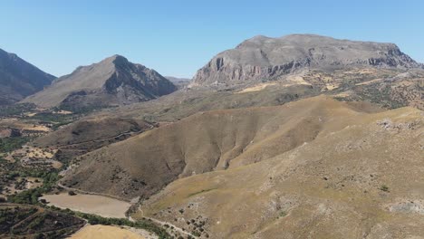 Aerial-panoramic-view-of-a-dramatic-landscape-formed-by-mountains,-valleys-and-gorges-at-the-south-of-Crete-island,-Greece