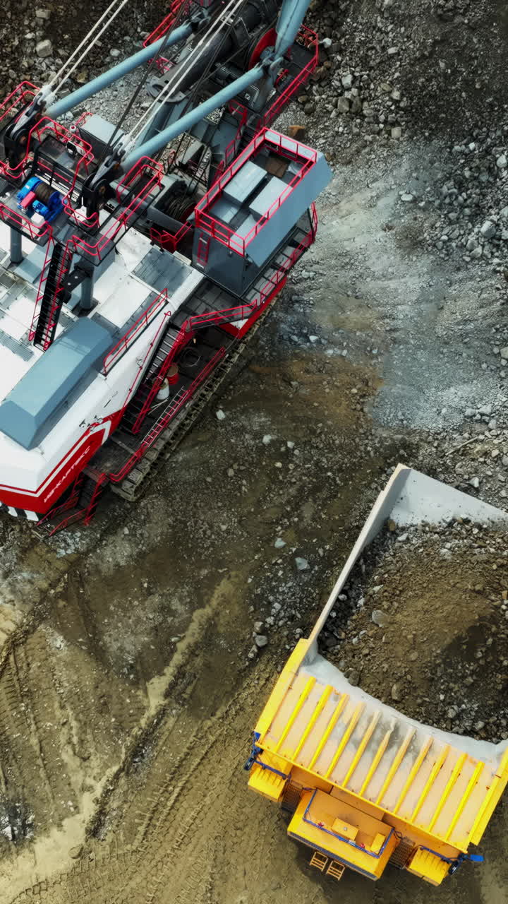 Aerial view of a large mining excavator and dump truck at a quarry