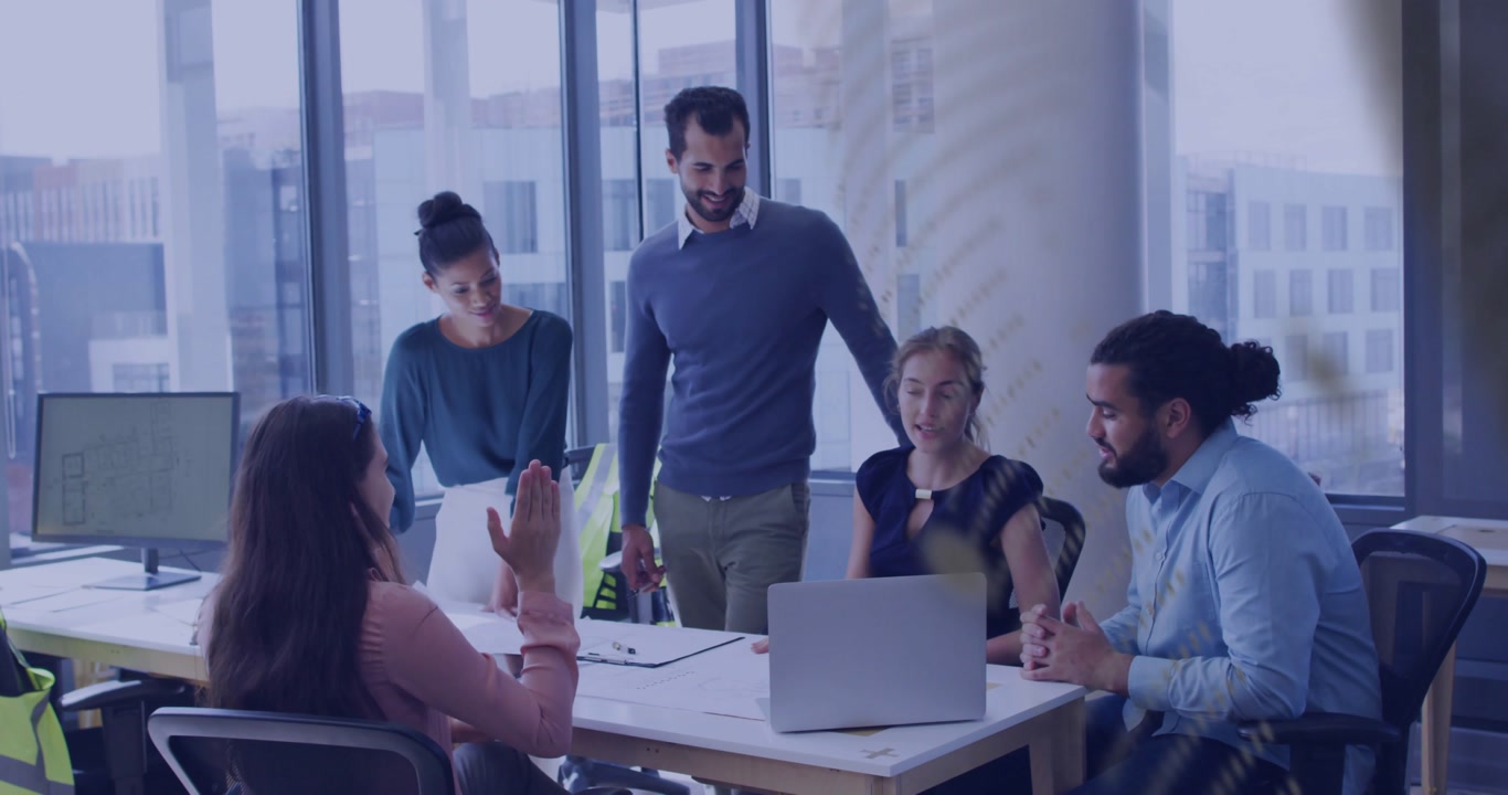 Business team reacting after woman at laptop pointing, reviewing project, patterned overlay moving