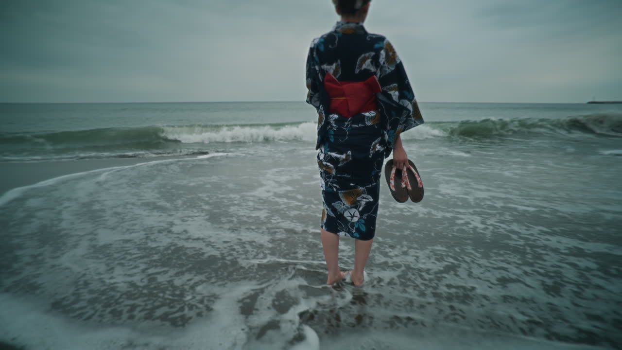 Woman in kimono on the beach