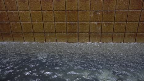 water stream falling from the wall creates the effect of droplets wave