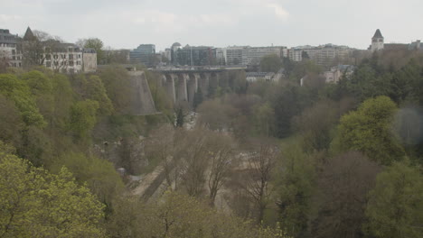 Tilt-up-from-beautiful-green-park-to-Passerelle-bridge-in-Luxembourg-city