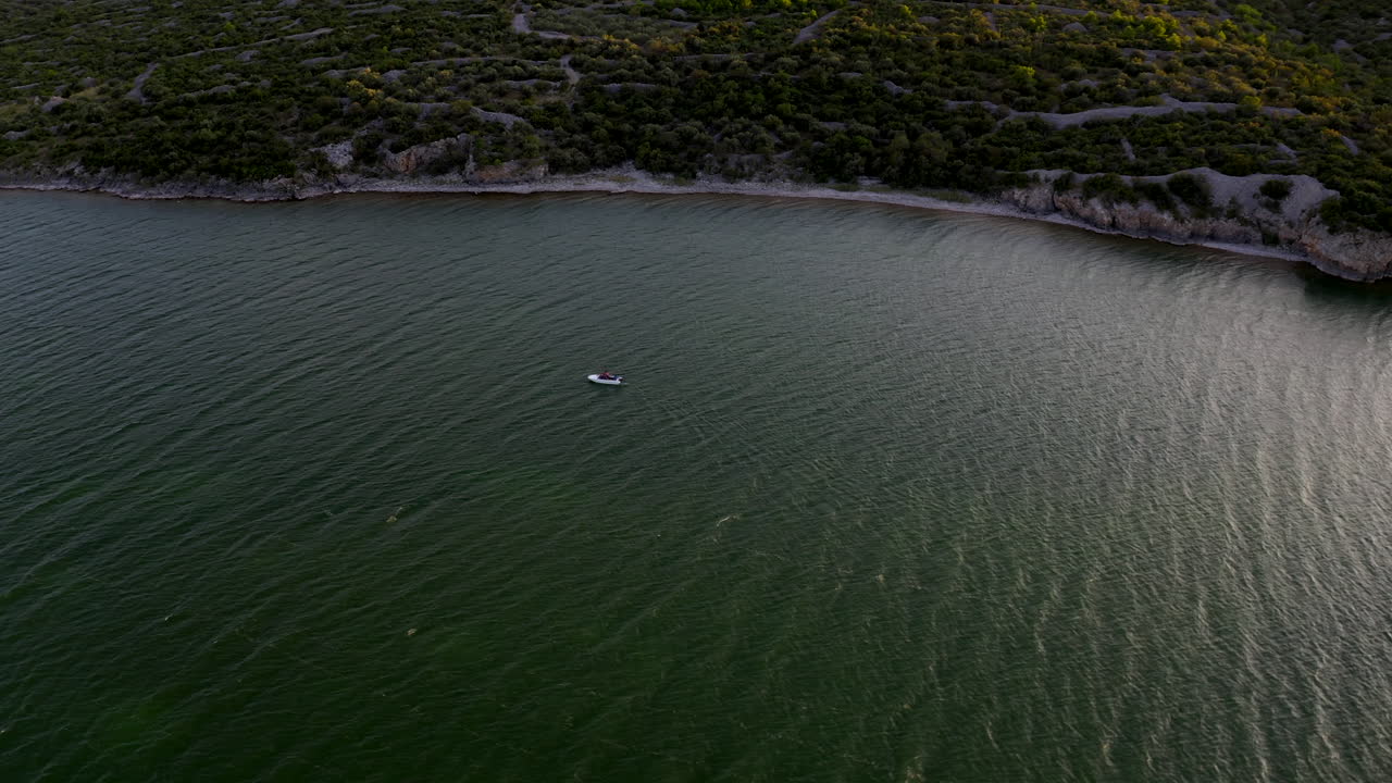 A boat is sailing on the sea during sunset in Croatia near Zadar.