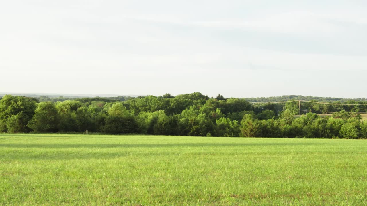 Panning shot of valley looking towards the mountains.