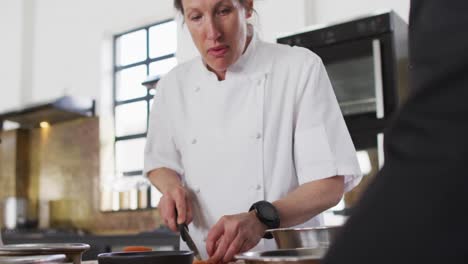 caucasian female chef teaching diverse group