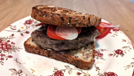 un delicioso sándwich o hamburguesa en una mesa, un primer plano de un almuerzo recién hecho con pan, lechuga, tomate y carne