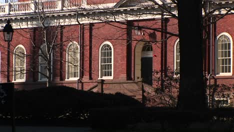 the camera focuses on a harvard university building designed in colonial style of architecture