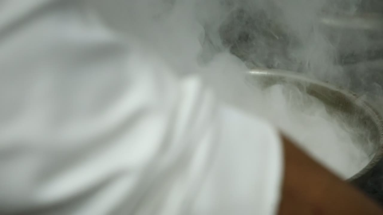 un jefe cocina comida en una parrilla cerca de la toma, inserción de la toma