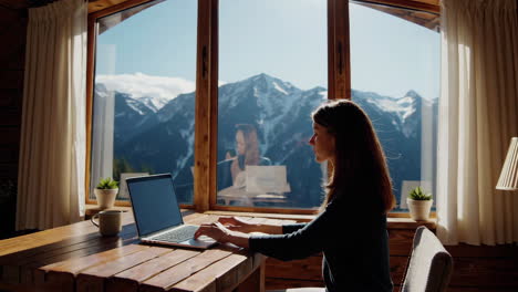 woman working on laptop with mountain view
