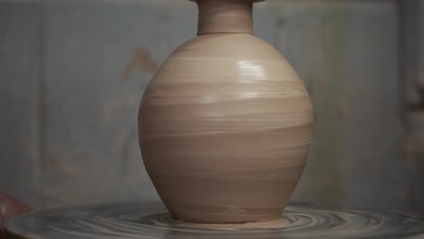 the potter makes a jug of clay. ceramist. a man makes a vase on a potter's wheel