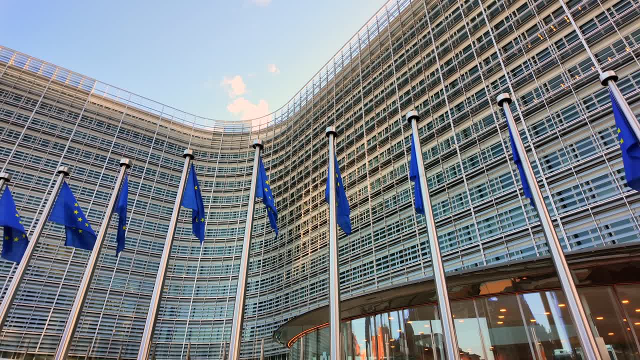 EU flags waving outside Berlaymont, Commission headquarters in Brussels