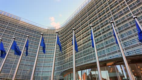 eu flags waving outside berlaymont, commission headquarters in brussels
