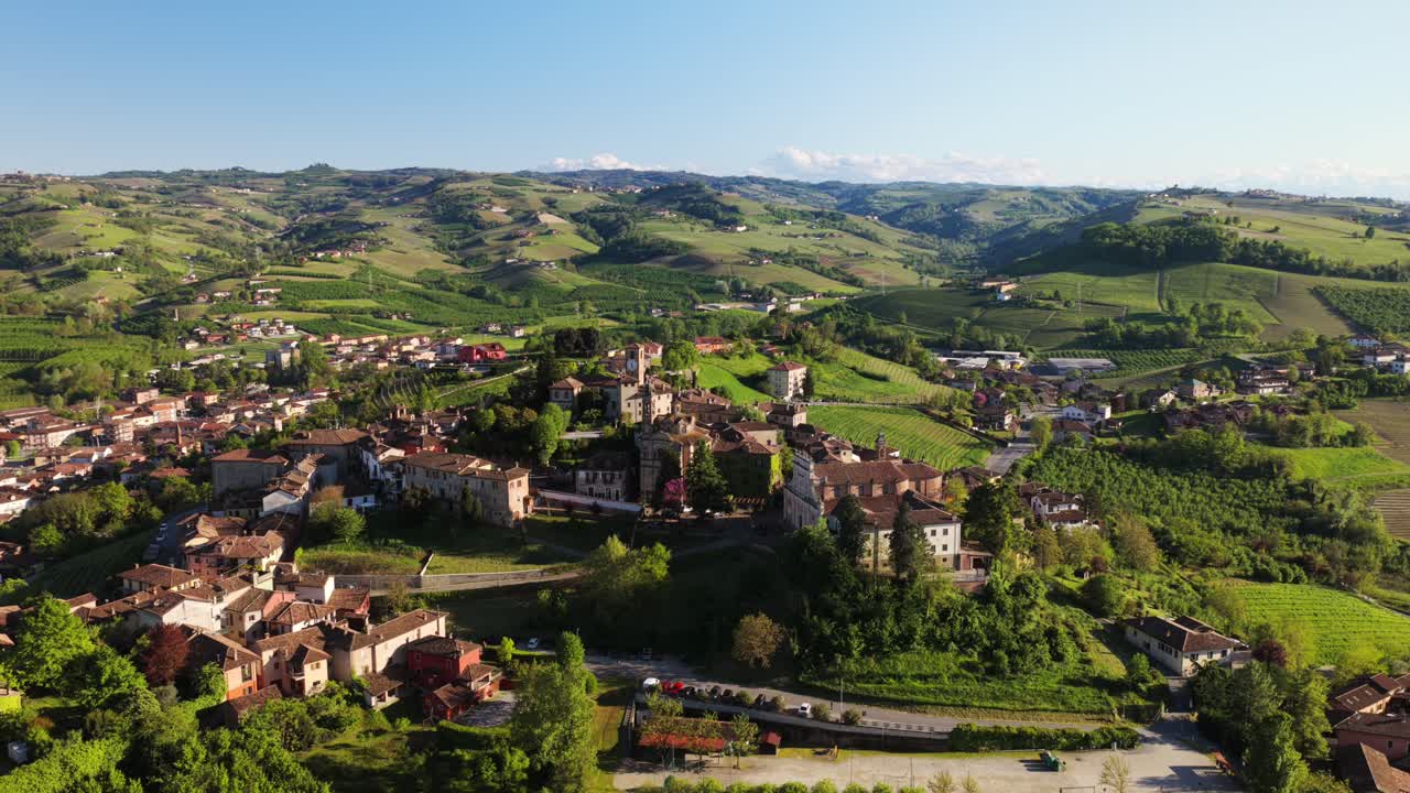 Drone footage showcasing dense historic architecture, terracotta rooftops, and narrow streets of Neive, charming medieval village in Langhe, Piedmont, Italy