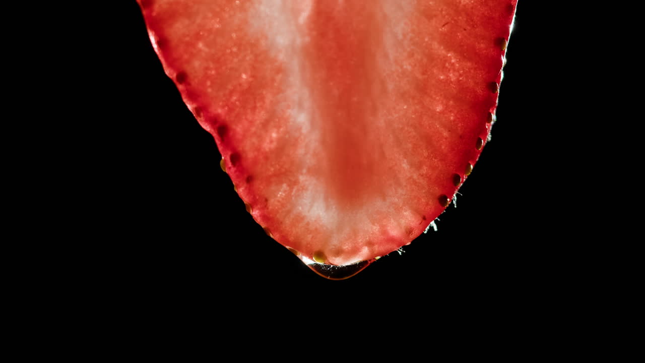 Close-up of a sliced strawberry with water droplet