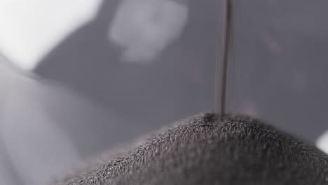 video of close up of hourglass with sand pouring, copy space on grey background